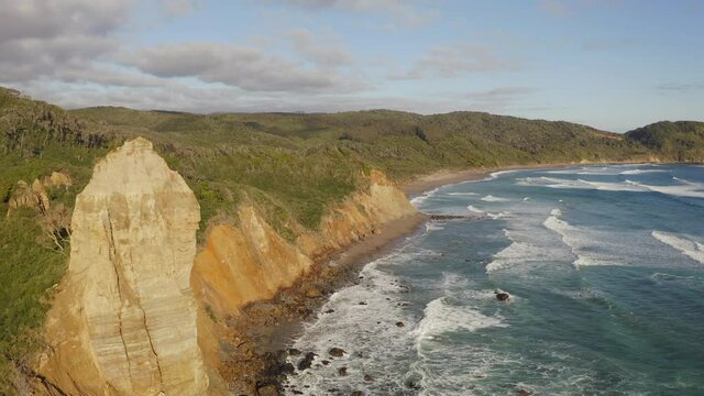 flying next to a big rock a Pacific Ocean