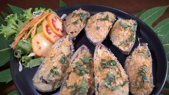 Delicious Mussels on a Spinning Plate with Decorated Side Salad.