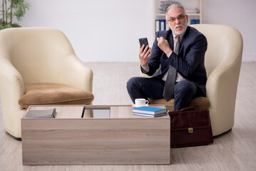 Fototapeta premium Old businessman employee waiting for business meeting