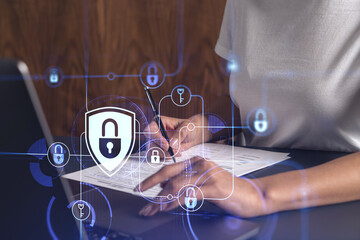 A businesswoman in casual wear signing the contract to prevent probability of risks in cyber...
