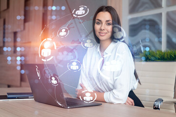 Attractive businesswoman in white shirt at workplace working with laptop to hire new employees for...