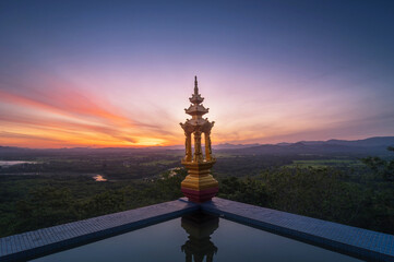 Fototapeta na wymiar Morning view with pool and lanterns at Wat Phra That Doi Phra Chan, Lampang, Thailand.