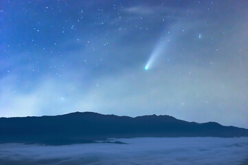 The sea of mist at night in the forest in the sky with meteors.