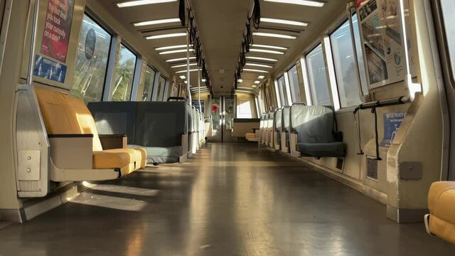 Pedestal Shot of an Aisle of an Empty Train During a Bright and Early Morning.