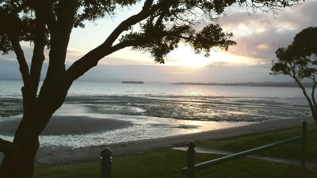 Drone footage revealing the sunrise at the Howick beach in East Auckland, New Zealand.