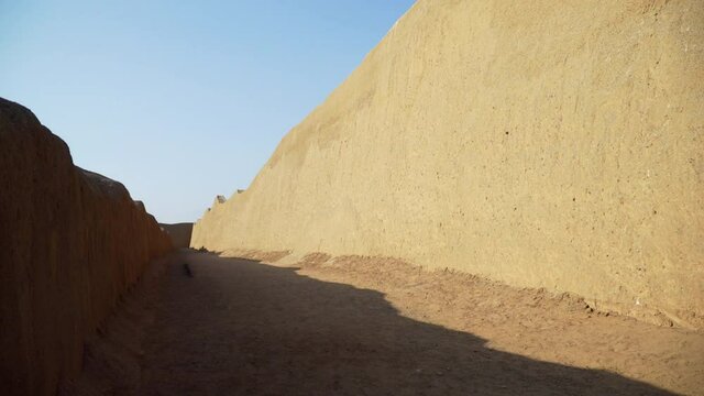 The Ancient Archeological Site of Chan Chan Capital in Trujillo, La Libertad, Peru. Panning Shot of Walls with Blue Skies.
