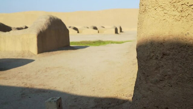 The Ancient Archeological Site of Chan Chan Capital in Trujillo, La Libertad, Peru. Panning Shot of Walls with Blue Skies. 