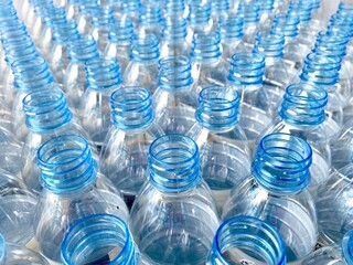 blue clear plastic unfilled drinking water bottle.