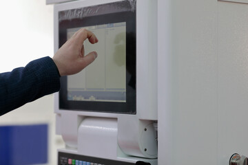 engineer controls modern equipment by touchscreen