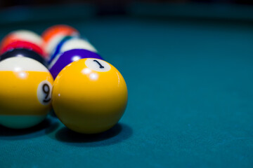 pool or billiards balls on  blue table . focus on the ball number 1