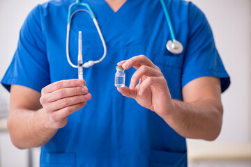 Young male doctor in vaccination concept during pandemic