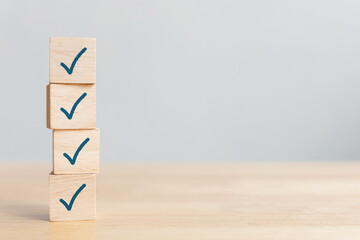 Checklist concept, Check mark on wooden blocks on table with copy space