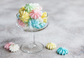 Small colorful meringues in the glass