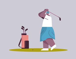 senior woman playing golf aged african american female player taking a shot active old age concept