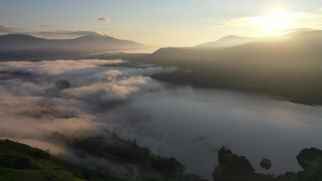 Aerial footage of a cloud inversion over Derwent Water and Keswick in the Lake District, Cumbria. Shot from the summit of catcalls with a drone at sunrise.