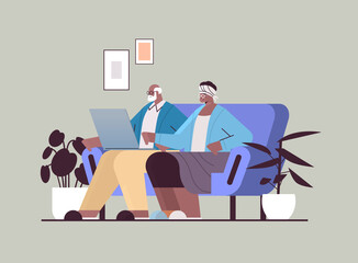 Fototapeta premium senior couple using laptop grandparents relaxing at home social media network online communication concept
