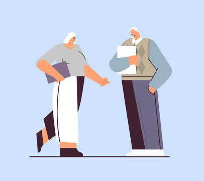 senior businesspeople discussing during meeting business man woman couple in formal wear standing together old age