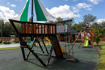 Fototapeta premium Empty playground for children for leisure and recreation with a toy in the park as a child in a natural style.