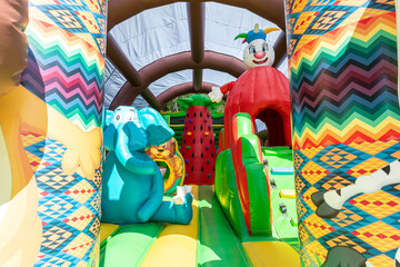 Close-up of a large inflatable trampoline with a lion and an elephant on the playground