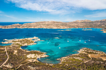 Fototapeta na wymiar View from above, stunning aerial view of La Maddalena Archipelago with its turquoise, crystal clear bays of water. Caprera Island in the distance. Sardinia, Italy.