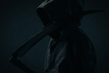 Man in a Death costume, a fictional mythical image for the day of Halloween, in dark colors.