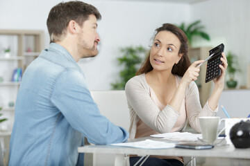 stressed wife and husband with many debts calculating family income