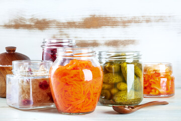 Fototapeta na wymiar Fermented, probiotic food. Canned vegetables. Pickles, sauerkraut and other organic preserves in mason jars. Healthy vegan cooking background with a place for text