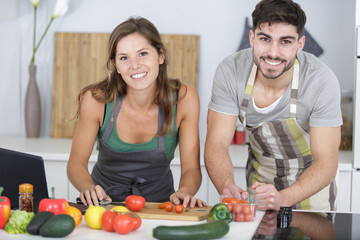 Obraz na płótnie Canvas husband and wife on chopping board in kitchen