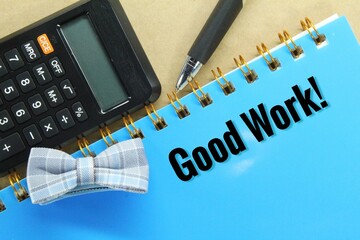 calculator, pen, tie, notebook with the word good work