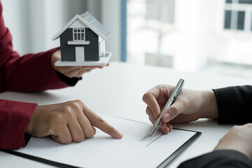 Real estate agents offer sale home insurance and close the sale immediately after the customer signs a purchase contract under a formal agreement. Real Estate Home insurance concept