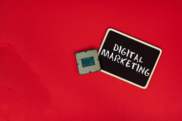 Small blackboard, a computer chip and text Digital Marketing. Business concept