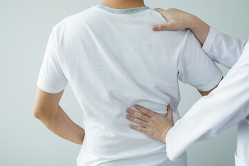 Female physiotherapists provide physical assistance to male patients with back injuries back massages for relaxation and muscle recovery in the rehabilitation center