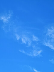 A bright blue sky and a few clouds
