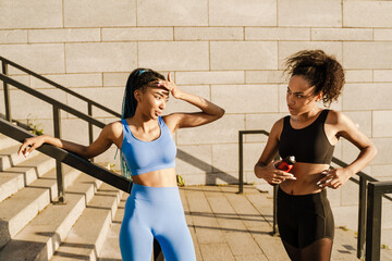 Fototapeta na wymiar Two young african women in sportswear exercising