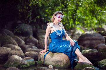 Mermaid of Sea in Artistic Caucasian Blond Woman With Strasses on Face Sitting in Blue Wet Dress on...