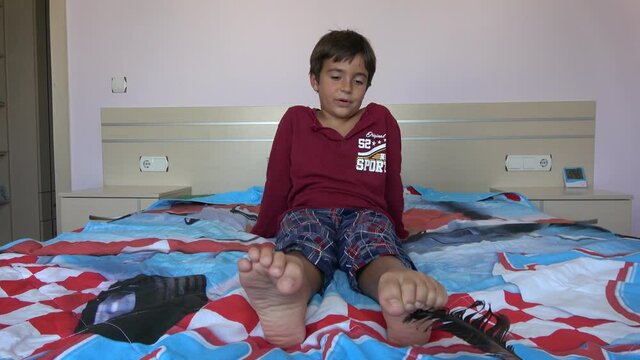 4K Black feather tickles childs feet

