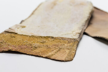 Extreme Texture Closeup of Pair of Brown Used Removable Shoe Insoles Placed Over White Background.