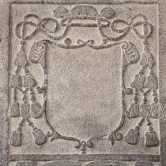 Detail of an ancient carved stone frame with ropes and tassels