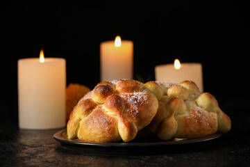 Bread of the dead and candles on dark background. Celebration of Mexico's Day of the Dead (El Dia de Muertos)