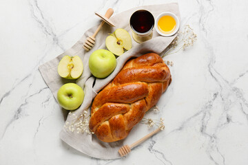 Honey with apples, challah and sacramental goblet of wine on white background. Rosh hashanah...