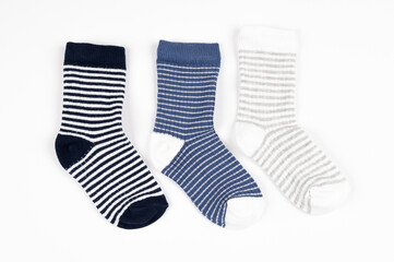 Three striped little baby boy socks isolated on white.