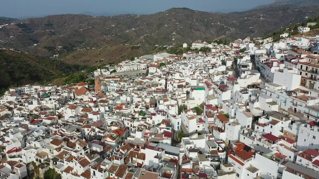 Aerial view of central areas of Competa overlooking parish Church of Assumption on sunny fall day, Andalusia, Spain. High quality 4k footage