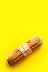 Tasty ciabatta sandwich on color background