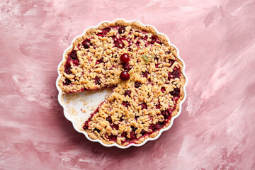 Baking dish with tasty cherry pie on color background