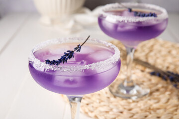Glasses of fresh cocktail with lavender on table, closeup