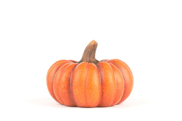 An orange pumpkin made out of clay isolated on white