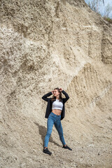 Fototapeta premium beautiful young woman in sand quarry, summer time
