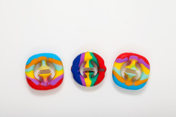 Three children's toys that develop fine motor skills. Fashionable silicone toys Snapperz on light background. Selective focus, place for text