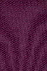 Burgundy woollen knitted fabric texture. Close up