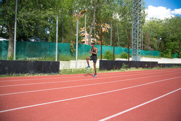 young african american man practicing running on running track